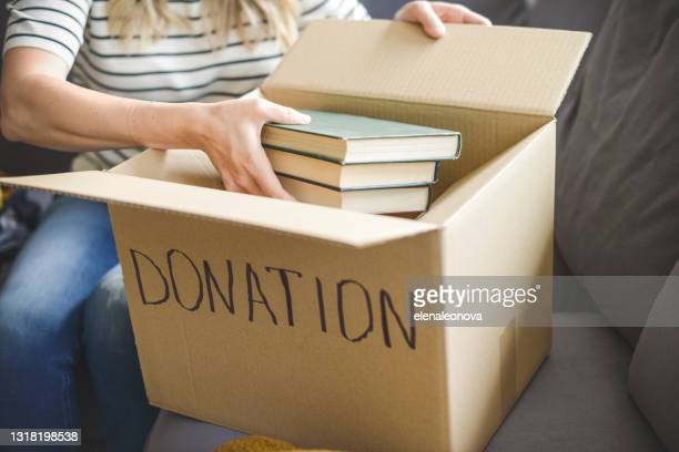 woman puts donations in a box